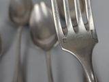 a close up of a fork and some spoons