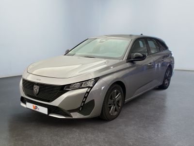 a silver car is parked in a room with a black floor