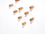 several wooden pegs are arranged on a white surface in a room
