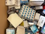a cardboard box full of electronics and other items