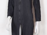 the mannequin is wearing a black dress with pleas on it
