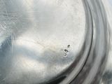 a close up of a metal object with a hole in it