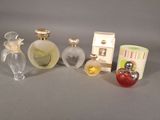 five different perfume bottles sitting next to each other on a table