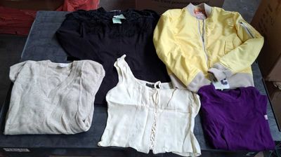 a lot of clothes that are sitting on a table