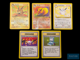 several pokemon cards are displayed on a black surface