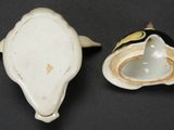 a white and black vase and a white and yellow vase