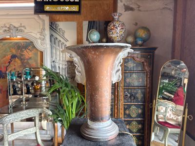 a large vase sitting on top of a table in the middle of a room