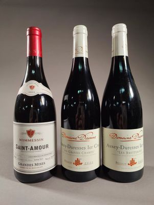 three bottles of wine are lined up on a table