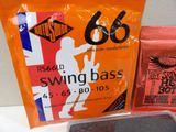 a bag of strings and a bag of guitar strings on a table