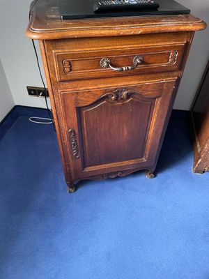 a wooden cabinet with a computer on top of it