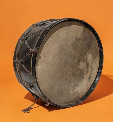 a close up of a drum on an orange background