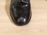 a close up of a person ' s shoes on a wooden floor