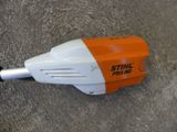 an orange and white blower sitting on top of a cement floor