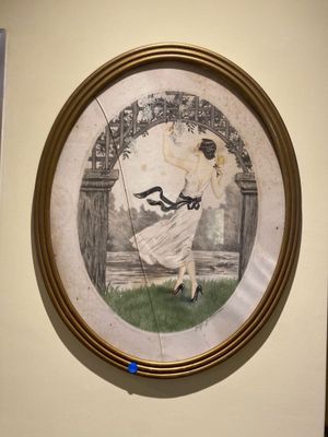 a picture of a woman in a white dress hanging on a wall