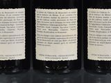 three bottles of wine are lined up on a table