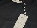 the back of a black dress with a tag on it