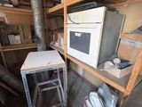 a white microwave sitting on top of a shelf in a room