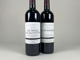 deux bouteilles de vin rouge posées l'une à côté de l'autre sur une table