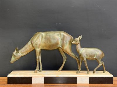 bronze sculpture of a mother and baby deer on a marble base