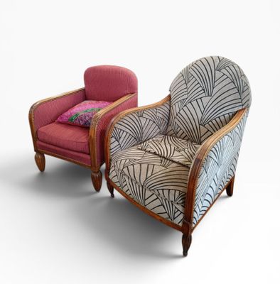 two chairs sitting next to each other on a white surface