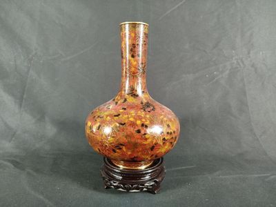 a vase that is sitting on a stand on a table