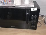 a microwave that is sitting on a counter with a tea kettle