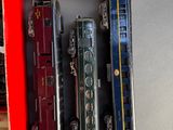 a lot of toy trains sitting on a shelf