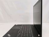 the back of a laptop computer sitting on top of a white table