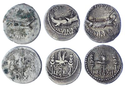 six ancient roman coins, one of which has a bird on it