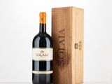 the bottle of red wine is next to a wooden box