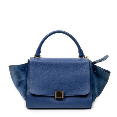 a small blue handbag with a gold buckle on the handle