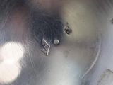 a close up of a metal bowl with a hole in it
