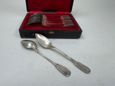 des couverts dans un coffret avec des cuillères et des cuillères posées sur une table