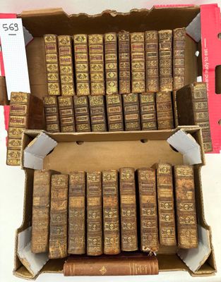 an open box of old books sitting on top of a table
