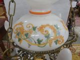 a white vase with a yellow and green design on it