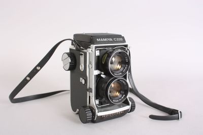 a black and white photo of a camera on a white surface