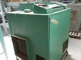 a green machine that is sitting on a pallet in a warehouse
