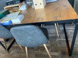 a table with two chairs and a birdhouse on top of it