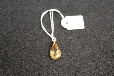 a close up of a necklace on a black surface with a price tag