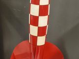 a red and white rocket shaped object on a table