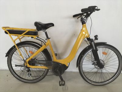 a yellow bicycle parked against a wall in a room