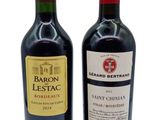 two bottles of wine that are sitting next to each other
