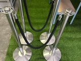 two metal poles that are on the grass near a bench