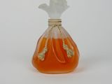 an orange perfume bottle with a white top sitting on top of a white surface