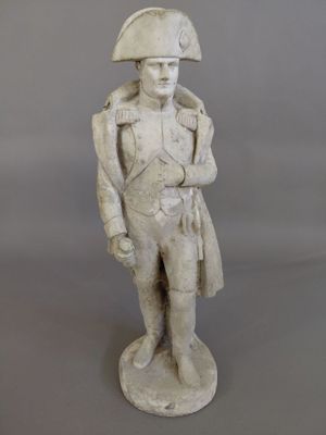 statue of a man with a hat and coat on a gray background