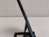 a close up of a cell phone on a stand on a table