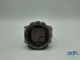 a close up of a watch on a white surface