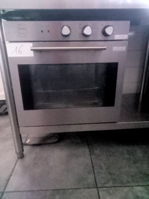 a stainless steel oven that is sitting on a tiled floor