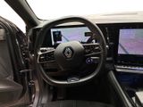 the interior of a car with a steering wheel, dashboard, and display screen