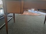 a desk with a chair and a rug on the floor